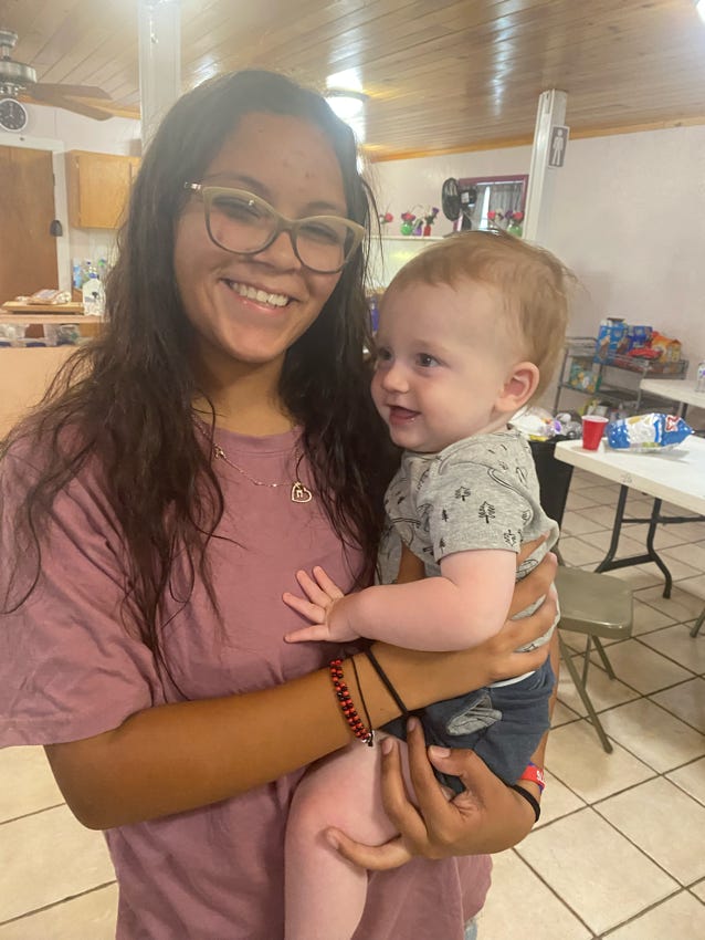 Student holding a child.