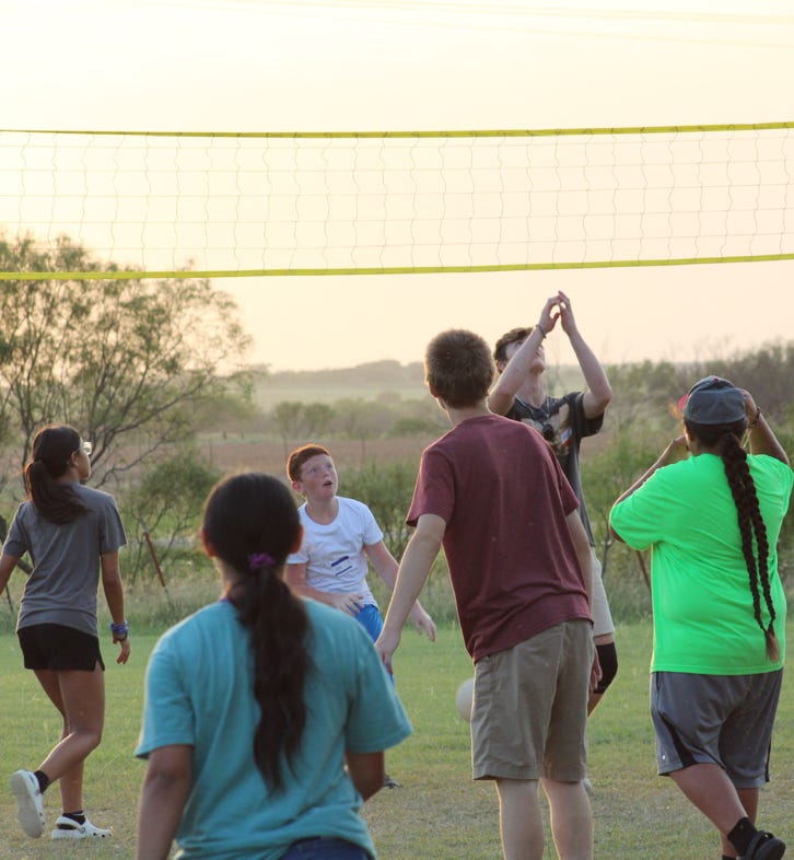 Members from our missions team playing volleyball with the youth. 